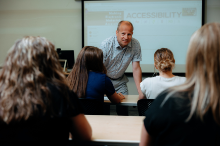 Professor in classroom teaching hands on