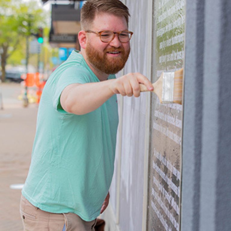 Isaac picture painting a mural